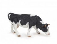 Krowa czarno-biała pasąca się - zdjęcie zabawki, gry
